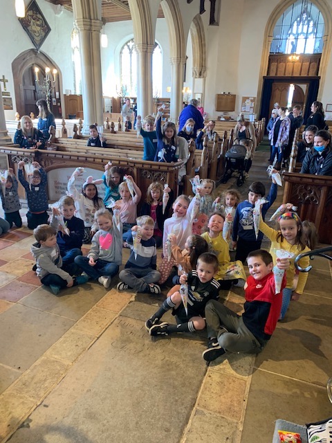 A group of children sitting in a church

Description automatically generated with medium confidence